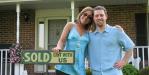 Happy Sellers! Sold Sign with Happy Couple